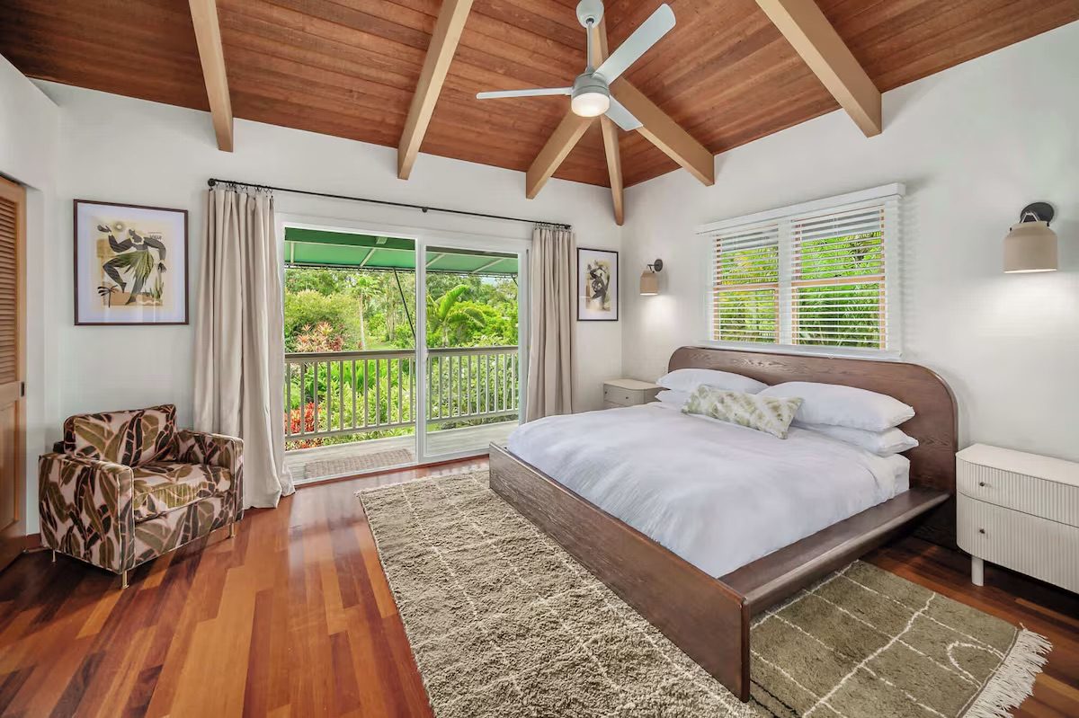 Bedroom with a king bed and sliding doors opening straight onto the covered lanai.