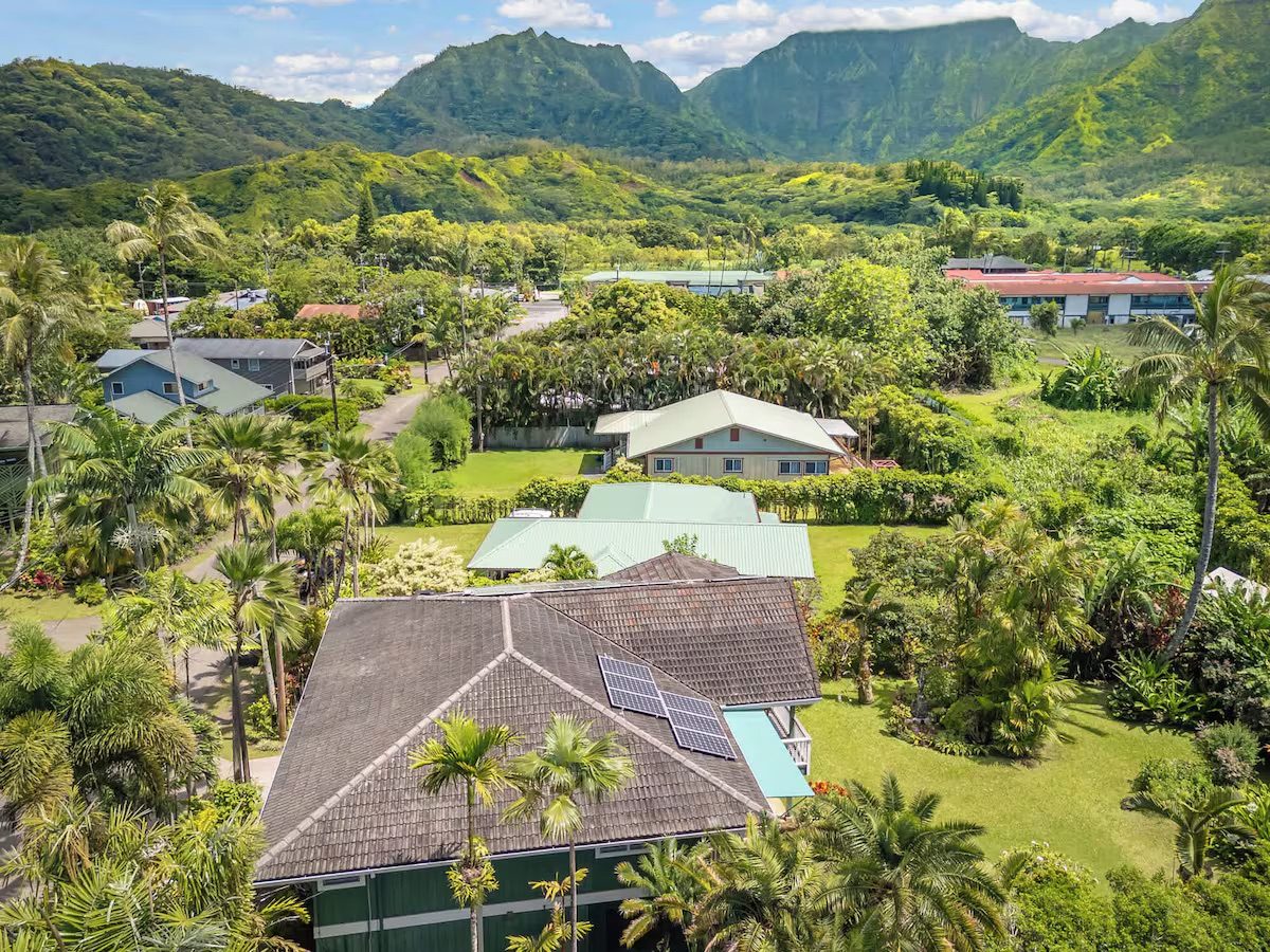 Aerial view of the property with the Nāmolokama mountains and waterfalls rising behind Hanalei.